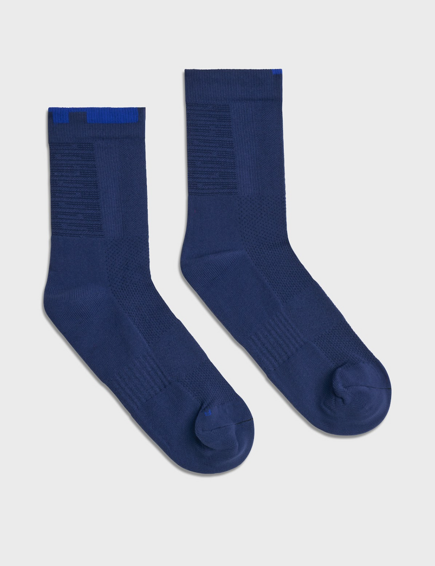 Pair of navy TIOTIO Performance Socks on a light grey background