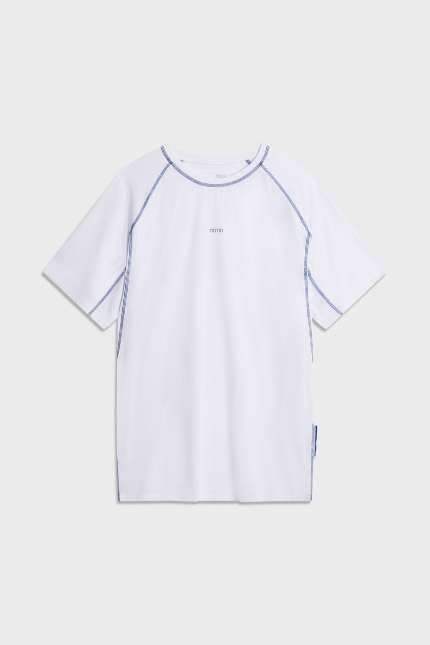 White TIOTIO Performance Tee laid flat on a light grey background
