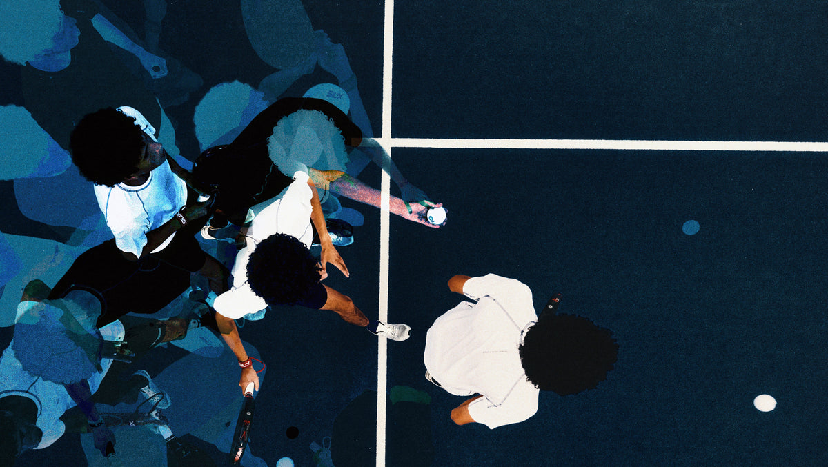 Overhead view of four players on a blue padel court mid-rally